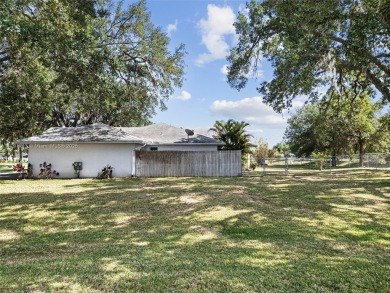 Located on a large corner lot along a peaceful canal, this on Spring Lake Golf Resort in Florida - for sale on GolfHomes.com, golf home, golf lot