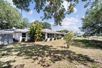 Located on a large corner lot along a peaceful canal, this on Spring Lake Golf Resort in Florida - for sale on GolfHomes.com, golf home, golf lot