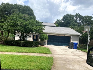 Discover this spacious two-story pool home tucked away in the on Carrollwood Country Club in Florida - for sale on GolfHomes.com, golf home, golf lot