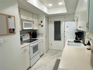 Under contract-accepting backup offers. Sunlight pours into this on Highland Lakes Executive Golf Course in Florida - for sale on GolfHomes.com, golf home, golf lot