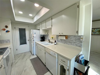 Under contract-accepting backup offers. Sunlight pours into this on Highland Lakes Executive Golf Course in Florida - for sale on GolfHomes.com, golf home, golf lot