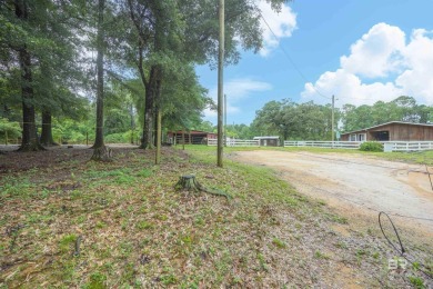 Nestled on a quiet corner lot near the Lawson Road entrance, and on Lake Forest Yacht and Country Club in Alabama - for sale on GolfHomes.com, golf home, golf lot