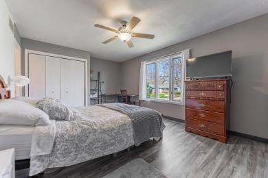 Charming cedar sided home creates a visual of a cozy cabin on Savannah Oaks Golf Club of Candlewick Lake in Illinois - for sale on GolfHomes.com, golf home, golf lot