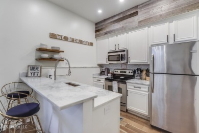 Step into coastal charm with this beautifully updated 2-bedroom on The Bridges Golf Club At Hollywood Casino in Mississippi - for sale on GolfHomes.com, golf home, golf lot