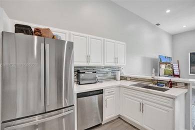 ENJOY LIVING & RELAXING IN THIS GORGEOUS REMODELED HOME WITH on Woodmont Country Club in Florida - for sale on GolfHomes.com, golf home, golf lot