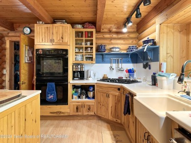 This expansive 5 bed, 3 bath log home offers a perfect blend of on Cedar Creek Golf Course in Wyoming - for sale on GolfHomes.com, golf home, golf lot