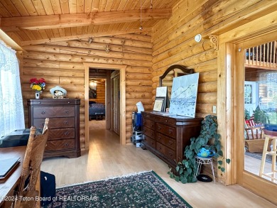 This expansive 5 bed, 3 bath log home offers a perfect blend of on Cedar Creek Golf Course in Wyoming - for sale on GolfHomes.com, golf home, golf lot