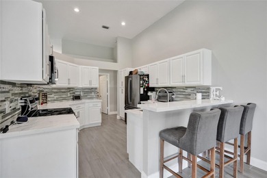 ENJOY LIVING & RELAXING IN THIS GORGEOUS REMODELED HOME WITH on Woodmont Country Club in Florida - for sale on GolfHomes.com, golf home, golf lot