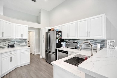 ENJOY LIVING & RELAXING IN THIS GORGEOUS REMODELED HOME WITH on Woodmont Country Club in Florida - for sale on GolfHomes.com, golf home, golf lot