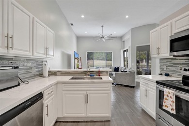 ENJOY LIVING & RELAXING IN THIS GORGEOUS REMODELED HOME WITH on Woodmont Country Club in Florida - for sale on GolfHomes.com, golf home, golf lot