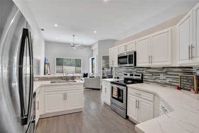 ENJOY LIVING & RELAXING IN THIS GORGEOUS REMODELED HOME WITH on Woodmont Country Club in Florida - for sale on GolfHomes.com, golf home, golf lot