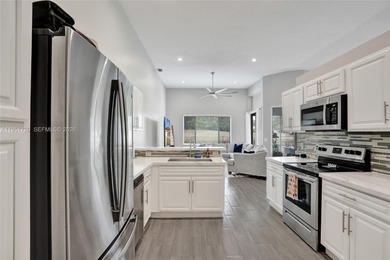 ENJOY LIVING & RELAXING IN THIS GORGEOUS REMODELED HOME WITH on Woodmont Country Club in Florida - for sale on GolfHomes.com, golf home, golf lot