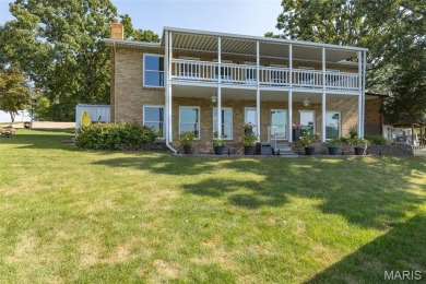 Enjoy stunning sunset lake views from this charming all-brick on Terre Du Lac Golf and Country Club in Missouri - for sale on GolfHomes.com, golf home, golf lot
