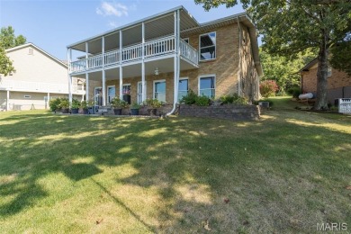 Enjoy stunning sunset lake views from this charming all-brick on Terre Du Lac Golf and Country Club in Missouri - for sale on GolfHomes.com, golf home, golf lot