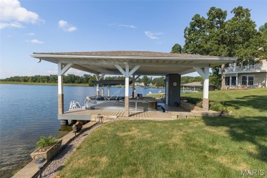 Enjoy stunning sunset lake views from this charming all-brick on Terre Du Lac Golf and Country Club in Missouri - for sale on GolfHomes.com, golf home, golf lot