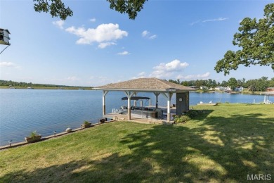 Enjoy stunning sunset lake views from this charming all-brick on Terre Du Lac Golf and Country Club in Missouri - for sale on GolfHomes.com, golf home, golf lot
