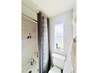 This charming two-bedroom, two-bathroom home is nestled in a on Pine Lakes Country Club in Florida - for sale on GolfHomes.com, golf home, golf lot