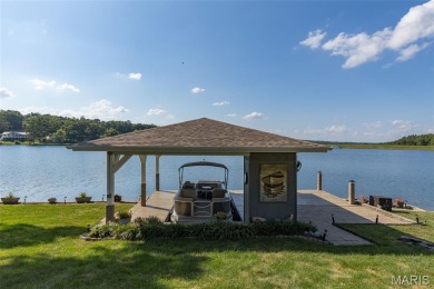 Enjoy stunning sunset lake views from this charming all-brick on Terre Du Lac Golf and Country Club in Missouri - for sale on GolfHomes.com, golf home, golf lot