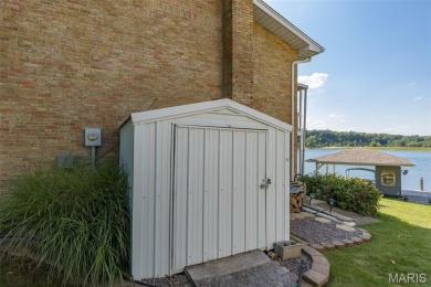 Enjoy stunning sunset lake views from this charming all-brick on Terre Du Lac Golf and Country Club in Missouri - for sale on GolfHomes.com, golf home, golf lot