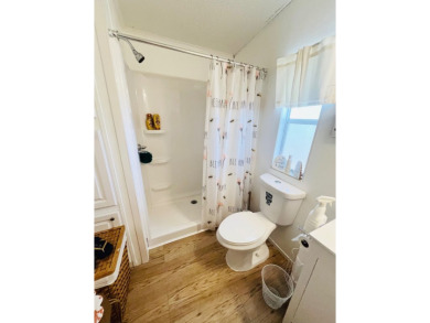 This charming two-bedroom, two-bathroom home is nestled in a on Pine Lakes Country Club in Florida - for sale on GolfHomes.com, golf home, golf lot