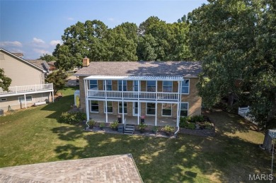 Enjoy stunning sunset lake views from this charming all-brick on Terre Du Lac Golf and Country Club in Missouri - for sale on GolfHomes.com, golf home, golf lot
