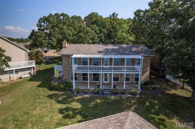 Enjoy stunning sunset lake views from this charming all-brick on Terre Du Lac Golf and Country Club in Missouri - for sale on GolfHomes.com, golf home, golf lot