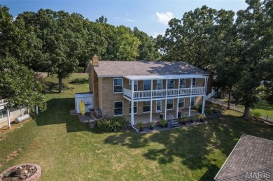 Enjoy stunning sunset lake views from this charming all-brick on Terre Du Lac Golf and Country Club in Missouri - for sale on GolfHomes.com, golf home, golf lot