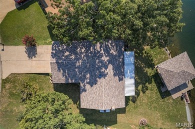Enjoy stunning sunset lake views from this charming all-brick on Terre Du Lac Golf and Country Club in Missouri - for sale on GolfHomes.com, golf home, golf lot