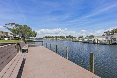 Nestled within the serene waterfront Mariners Pass community on Mangrove Bay Golf Course in Florida - for sale on GolfHomes.com, golf home, golf lot