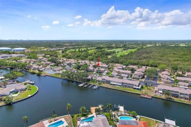 Nestled within the serene waterfront Mariners Pass community on Mangrove Bay Golf Course in Florida - for sale on GolfHomes.com, golf home, golf lot
