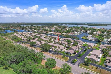 Nestled within the serene waterfront Mariners Pass community on Mangrove Bay Golf Course in Florida - for sale on GolfHomes.com, golf home, golf lot