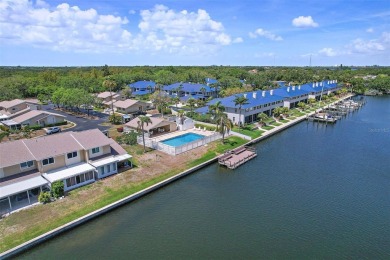 Nestled within the serene waterfront Mariners Pass community on Mangrove Bay Golf Course in Florida - for sale on GolfHomes.com, golf home, golf lot