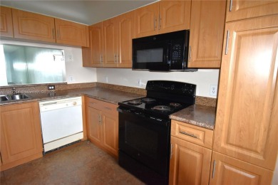 Spacious 2-bedroom 2 bath condo offers a good size kitchen with on Sunrise Lakes Phase IV Golf Course in Florida - for sale on GolfHomes.com, golf home, golf lot