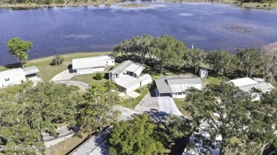 Welcome to paradise!  This lakefront home on Tooke Lake is on Glen Lakes Country Club in Florida - for sale on GolfHomes.com, golf home, golf lot