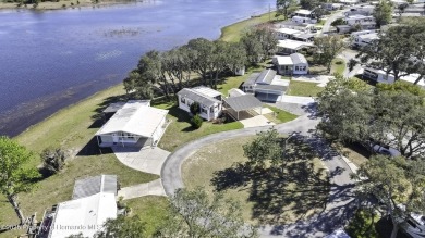 Welcome to paradise!  This lakefront home on Tooke Lake is on Glen Lakes Country Club in Florida - for sale on GolfHomes.com, golf home, golf lot