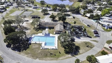 Welcome to paradise!  This lakefront home on Tooke Lake is on Glen Lakes Country Club in Florida - for sale on GolfHomes.com, golf home, golf lot