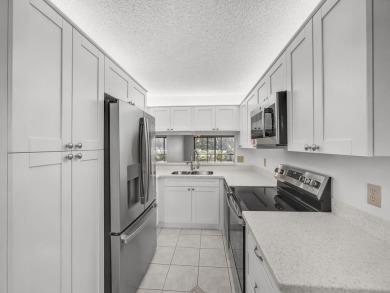 Rarely Available First Floor End Unit with views of the 7th hole on The Golf Club of Jupiter in Florida - for sale on GolfHomes.com, golf home, golf lot