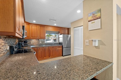 Welcome home to Mediterranean Manor, an idyllic waterfront on The Dunedin Country Club in Florida - for sale on GolfHomes.com, golf home, golf lot