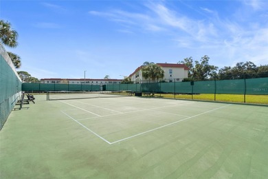 Welcome home to Mediterranean Manor, an idyllic waterfront on The Dunedin Country Club in Florida - for sale on GolfHomes.com, golf home, golf lot