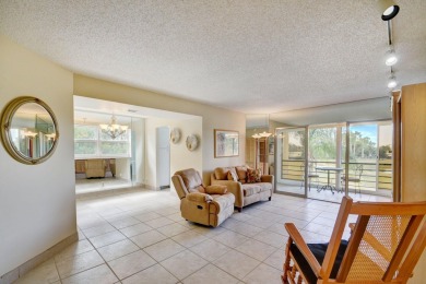 Discover your perfect retreat in this bright corner unit nestled on Poinciana Golf Club in Florida - for sale on GolfHomes.com, golf home, golf lot