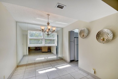 Discover your perfect retreat in this bright corner unit nestled on Poinciana Golf Club in Florida - for sale on GolfHomes.com, golf home, golf lot