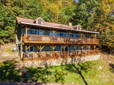 Offered FULLY FURNISHED, this stunning mountain retreat sits at on Wolf Laurel Country Club in North Carolina - for sale on GolfHomes.com, golf home, golf lot