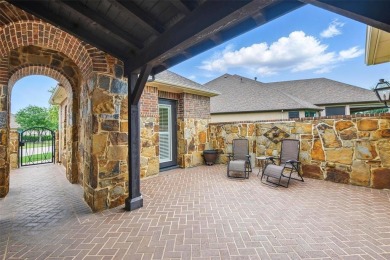 Situated directly on the 5th green, this luxury residence offers on Wildhorse Golf Club of Robson Ranch in Texas - for sale on GolfHomes.com, golf home, golf lot