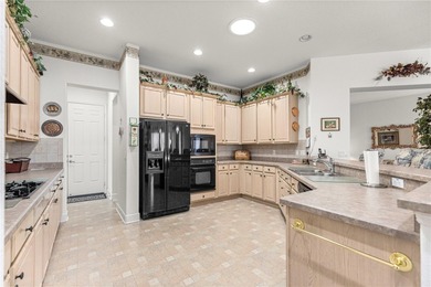 Luxurious Hampton model boasts French glass double French doors on Eagle Ridge At Spruce Creek Country Club in Florida - for sale on GolfHomes.com, golf home, golf lot