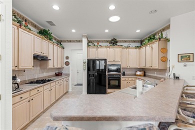 Luxurious Hampton model boasts French glass double French doors on Eagle Ridge At Spruce Creek Country Club in Florida - for sale on GolfHomes.com, golf home, golf lot