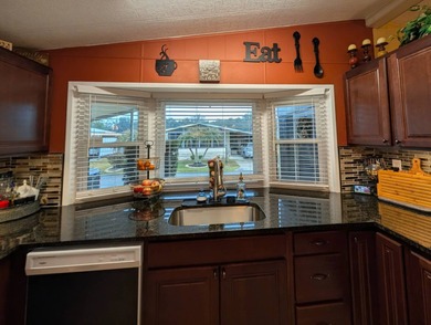 Experience the pinnacle of 55+ living in this impeccably on Grasslands Golf and Country Club in Florida - for sale on GolfHomes.com, golf home, golf lot