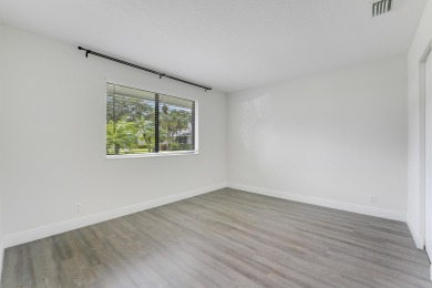Located in the highly desirable Club Cottages within PGA on PGA National Golf Club in Florida - for sale on GolfHomes.com, golf home, golf lot