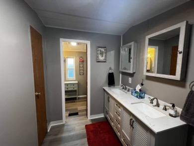 This beautifully updated 2-bedroom, 2-bathroom unfurnished home on Lake Henry Golf Club in Florida - for sale on GolfHomes.com, golf home, golf lot