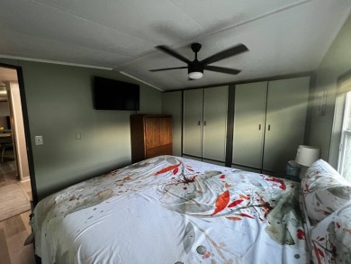 This beautifully updated 2-bedroom, 2-bathroom unfurnished home on Lake Henry Golf Club in Florida - for sale on GolfHomes.com, golf home, golf lot