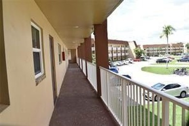 Two-bedroom, two-bathroom corner unit in the second floor in the on Sunrise Lakes Phase III in Florida - for sale on GolfHomes.com, golf home, golf lot